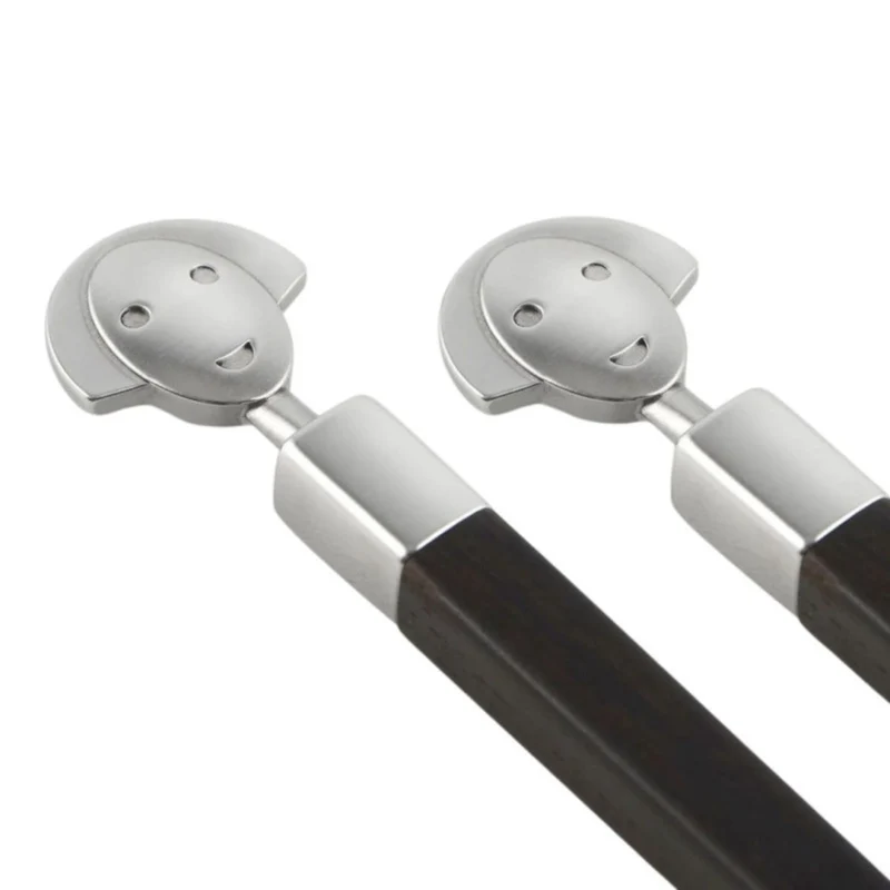 Conjunto de dos palillos de ébano con soporte de inox Alessandro Mendini Alessi